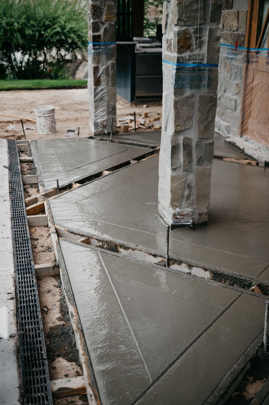 A freshly poured slab set around stone columns with its joints already cut