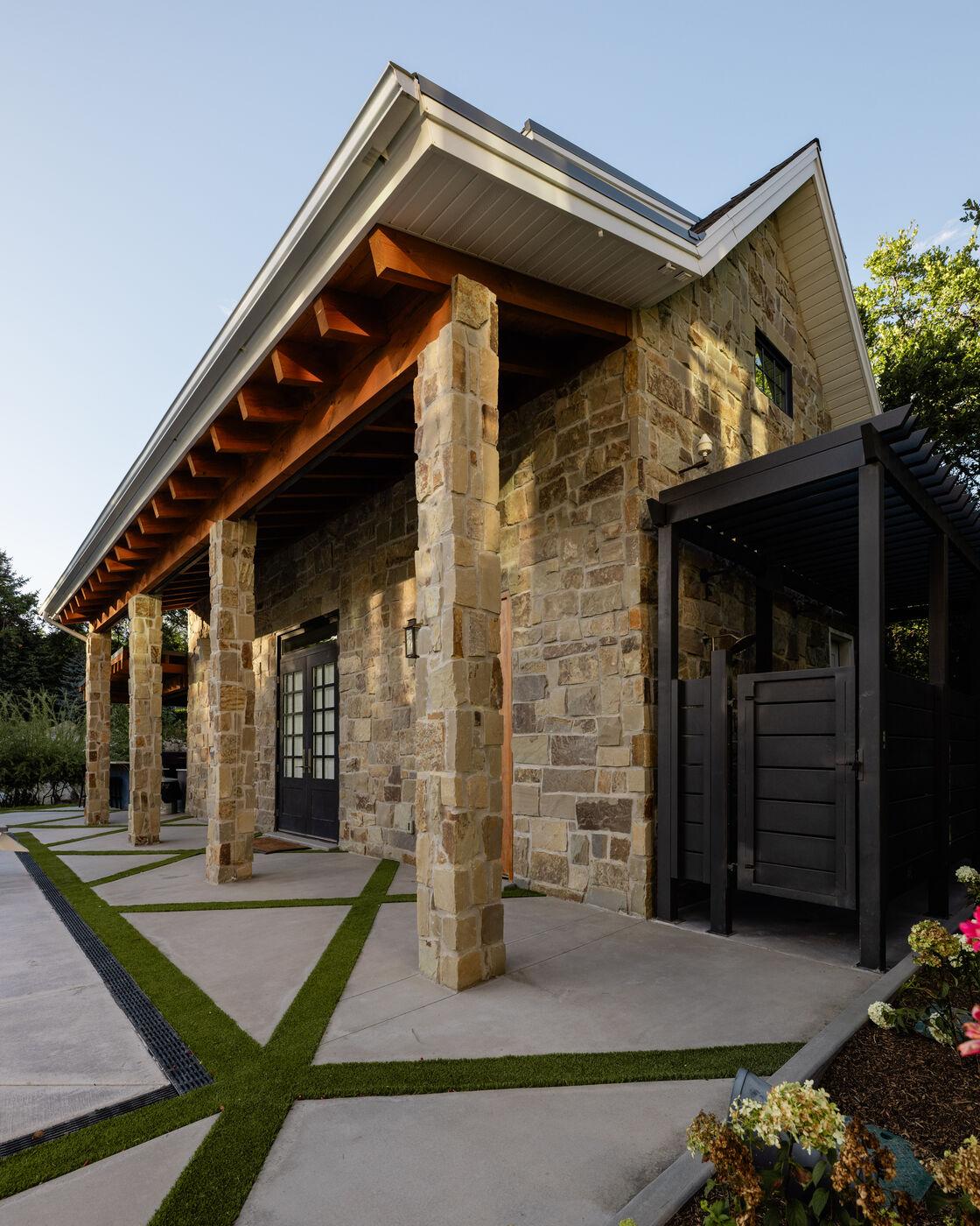 A stone-and-timber pavilion with paving running out to its columns