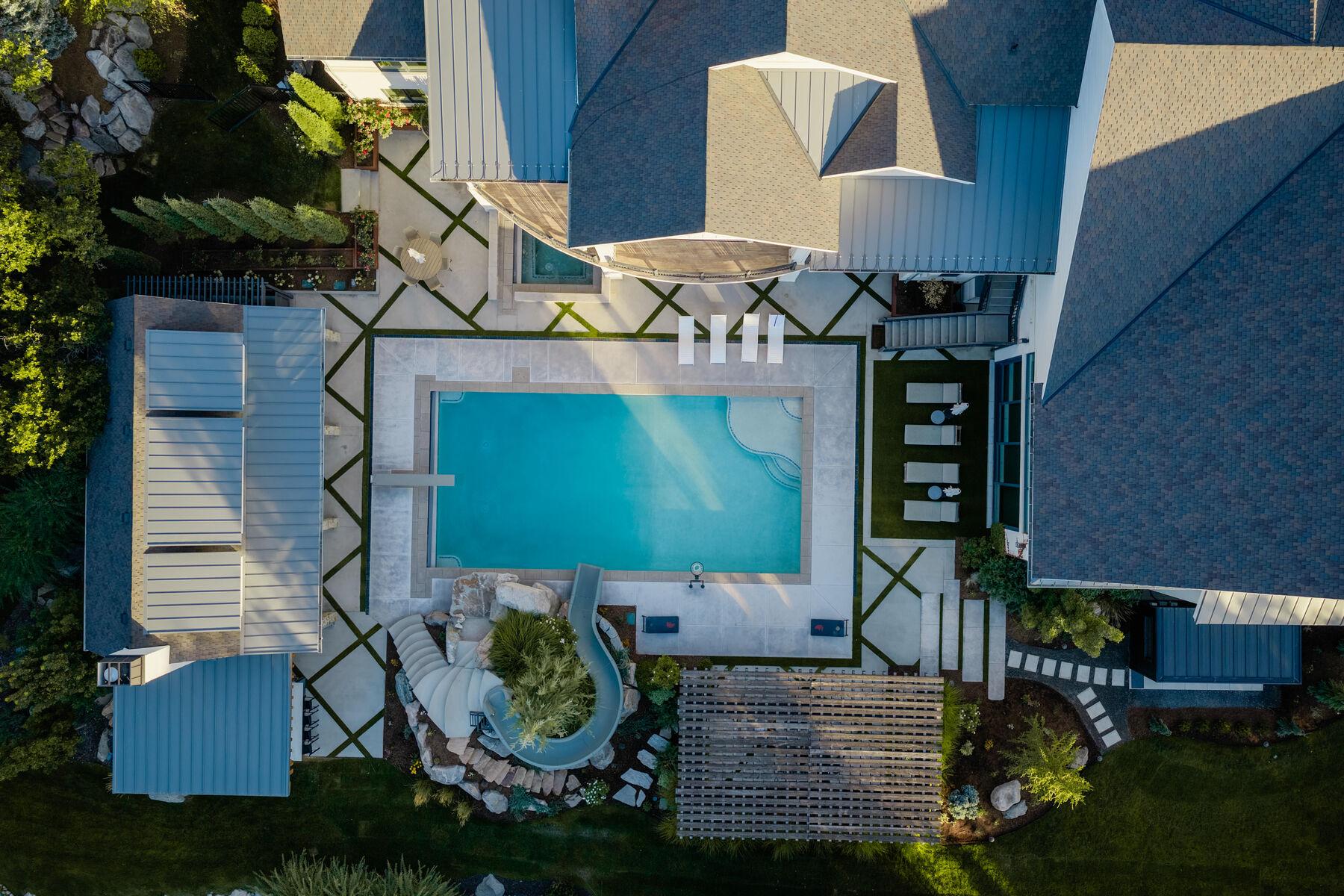 Overhead view of a pool, its decking, and the planting beds framing it